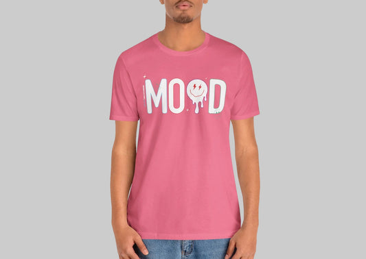 Person wearing a pink t-shirt with 'MOOD' print on a white background by WordCulture Streetwear.