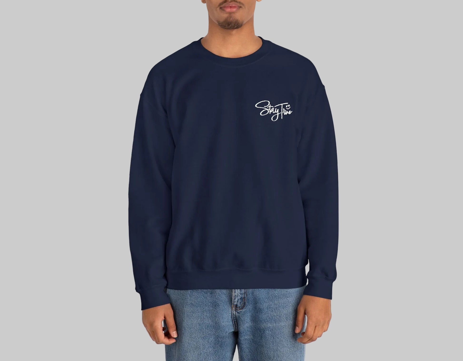 Person wearing a navy blue sweatshirt with a logo on a white background