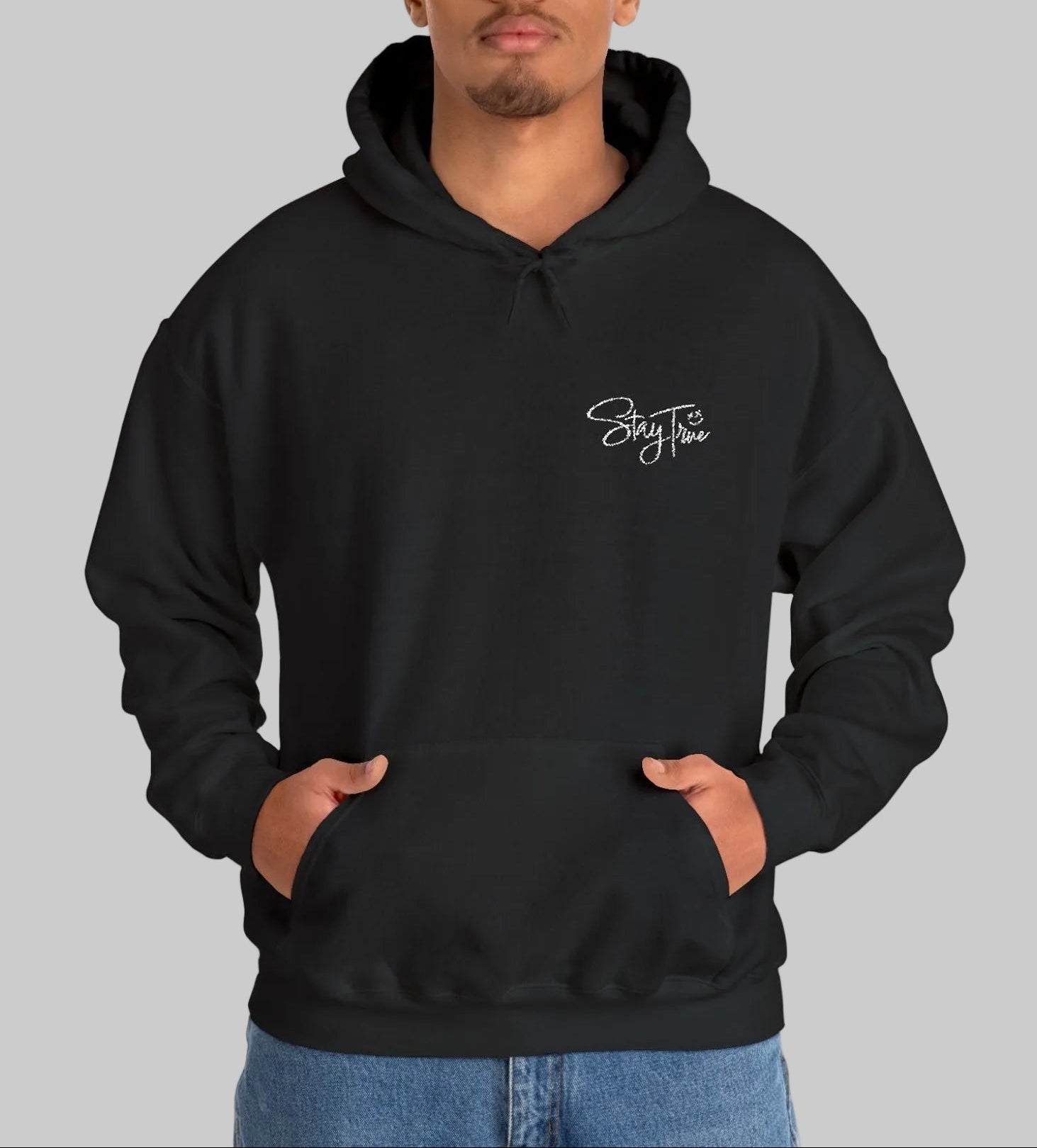 Man wearing a black heavy weight hoodie with white Stay True lettering design by WCS.