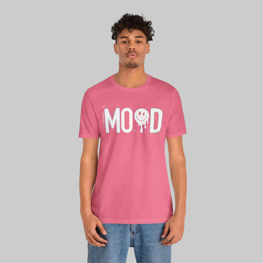 Person wearing a pink t-shirt with 'MOOD' print on a white background by WordCulture Streetwear.