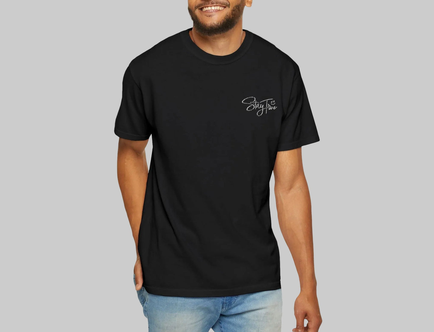 Man wearing a black t-shirt with 'stay true' text on a white background