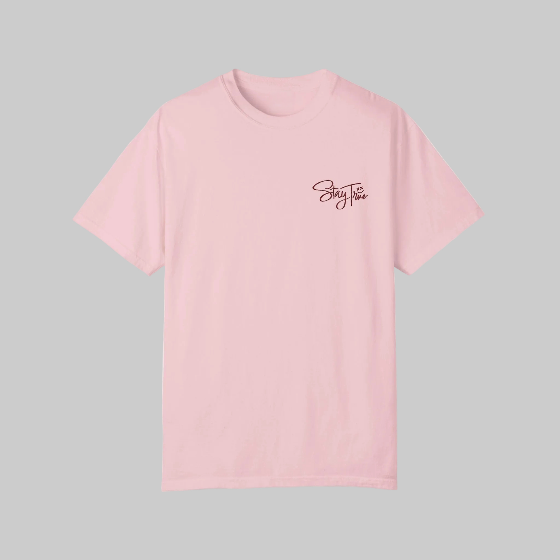 Pink t-shirt with 'Stay True' text on a gray background