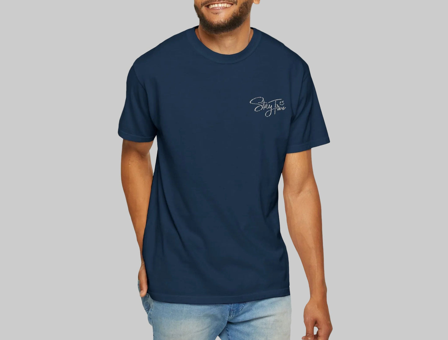 Man wearing a navy blue t-shirt with a logo on a white background