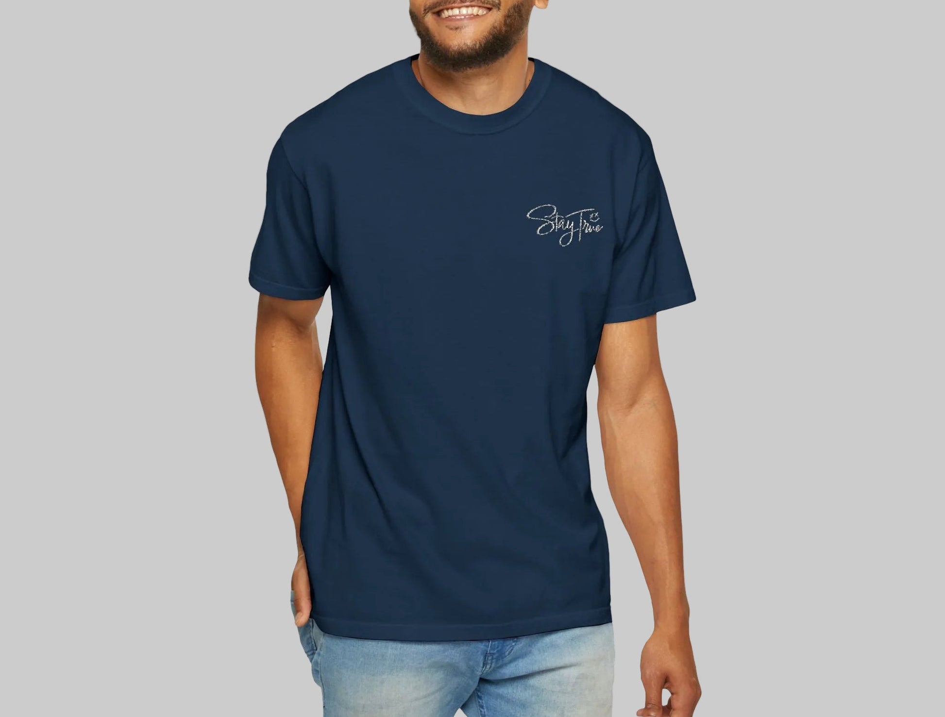 Man wearing a navy blue t-shirt with a logo on a white background
