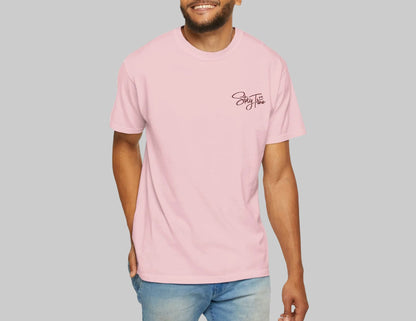 Man wearing a pink t-shirt with a logo on a white background