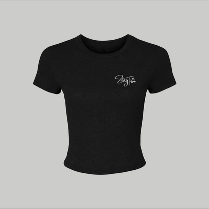 Black crop top with a white logo on a light gray background