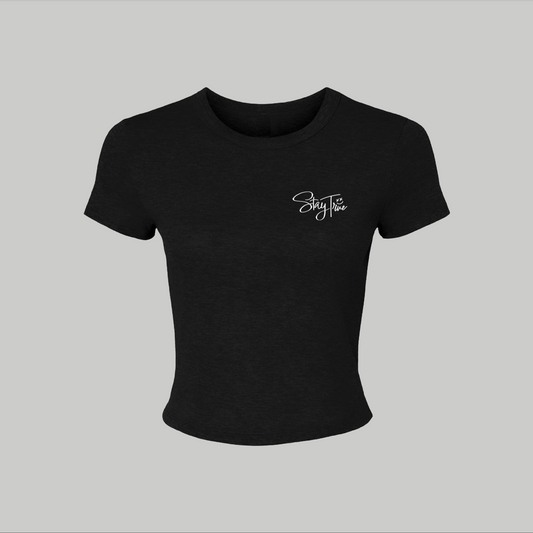 Black crop top with a white logo on a light gray background
