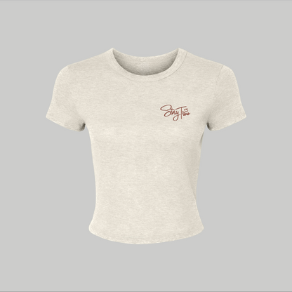 Beige crop top with a logo on a gray background