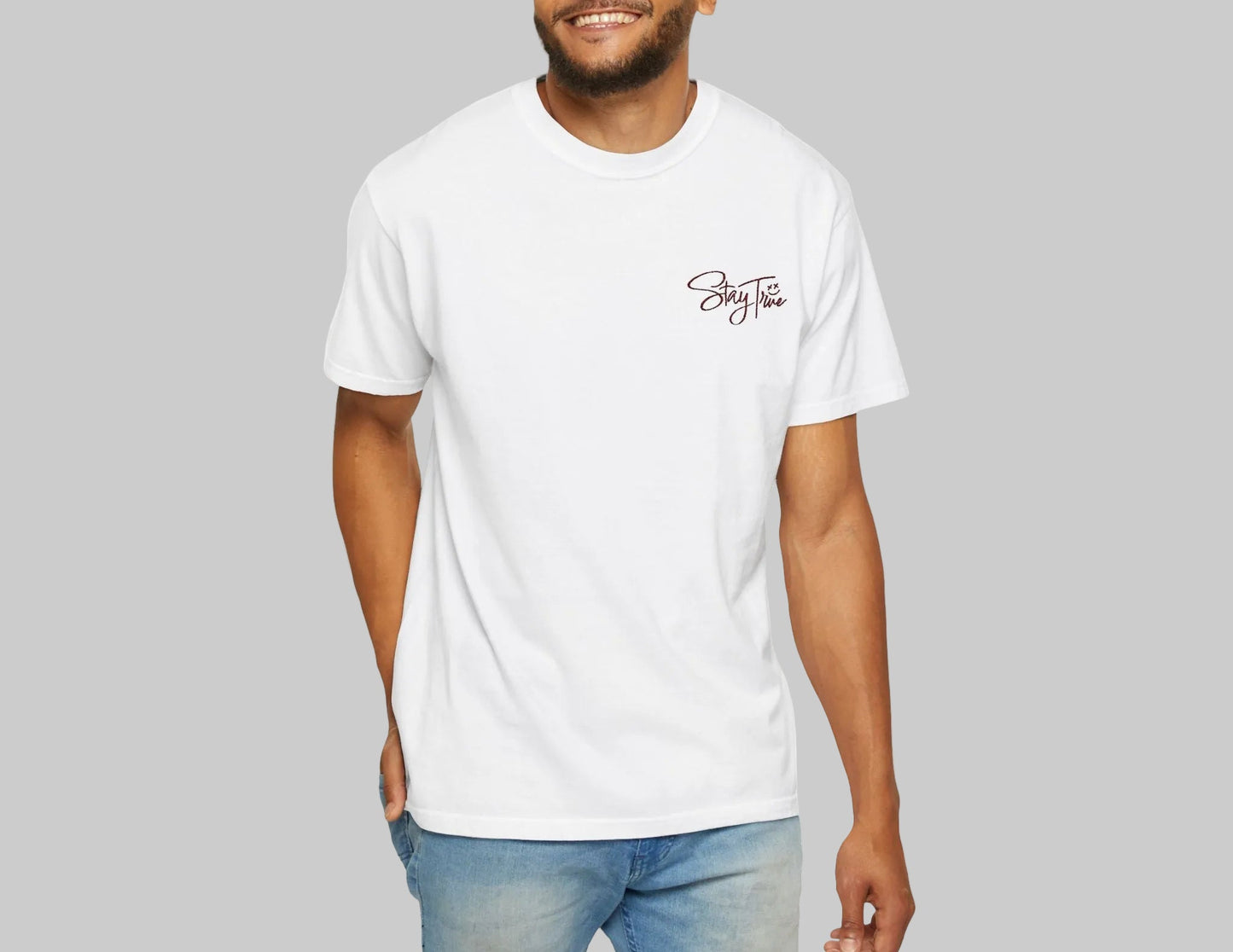 Man wearing a white t-shirt with Stay True design on a white background.