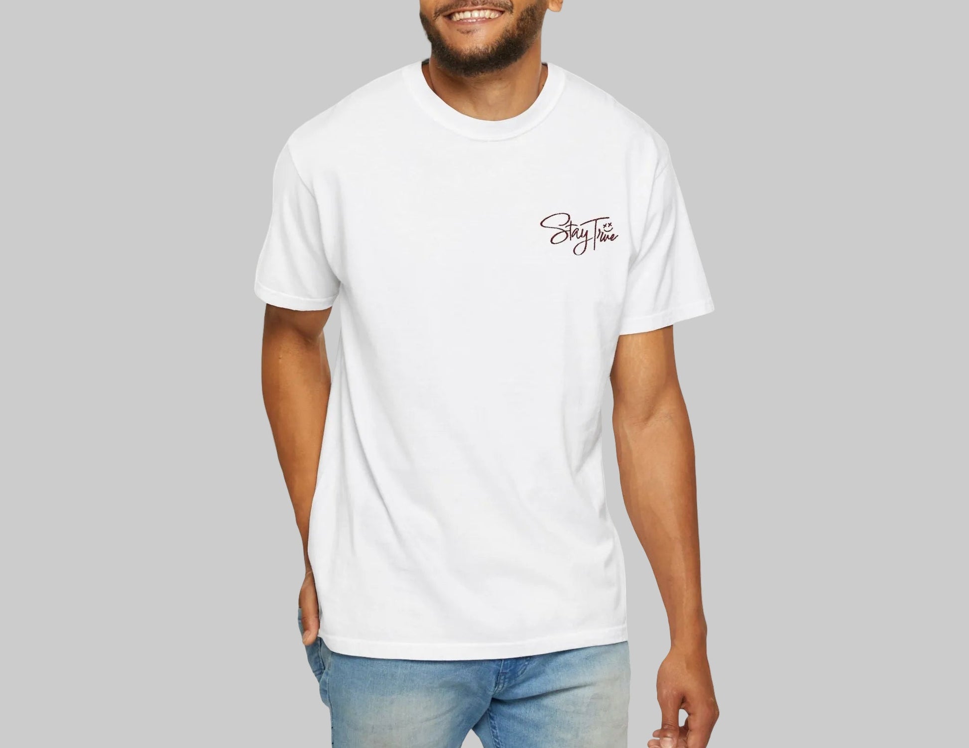 Man wearing a white t-shirt with Stay True design on a white background.